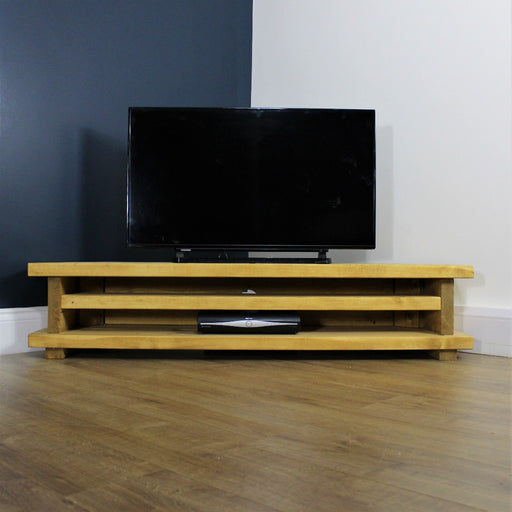 Solid wood corner TV unit with 2 shelves for all your media equipment. Finished in a rustic chunky style, handcrafted in the New Forest.